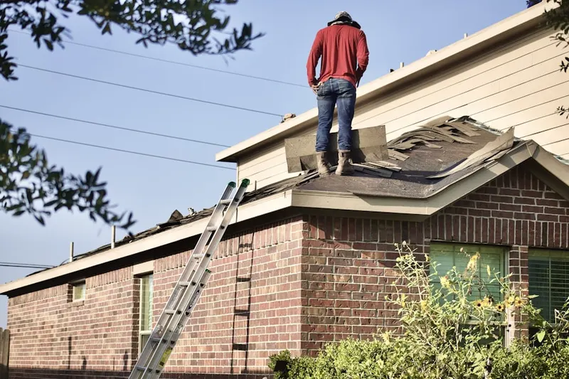 Professional roofer working on a residential roof in The Gables